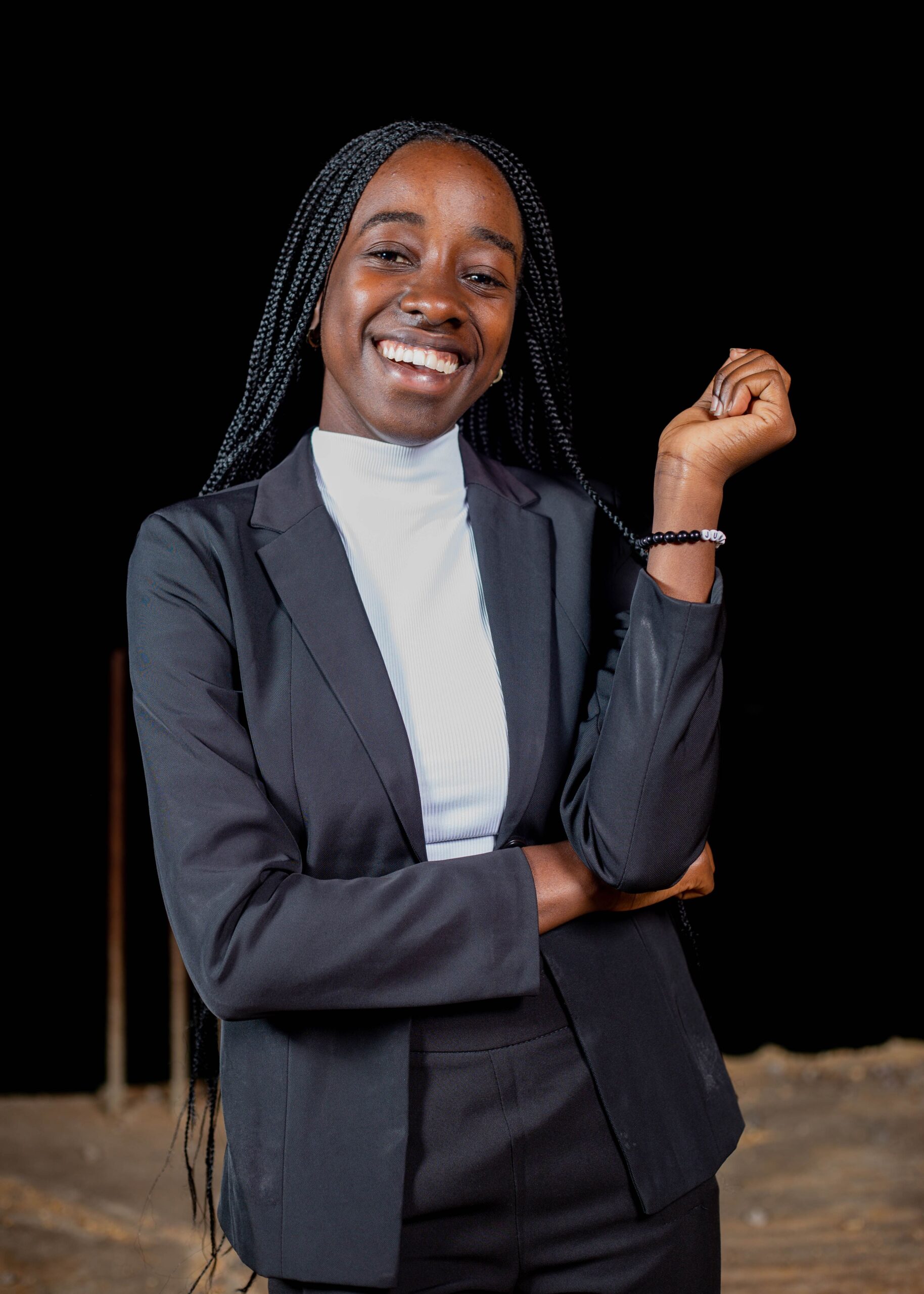 Portrait of a smiling businesswoman in a suit, exuding confidence and professionalism.